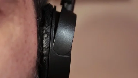 Close-up, headphones to a man's ear while listening to loud music Stock Footage 121680852