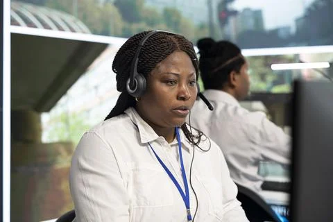 Close up of headset operator watching live road camera feeds Stock Photos