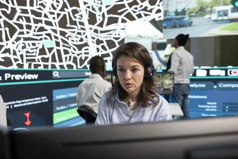 Close up of headset operator watching traffic CCTV footage Stock Photos