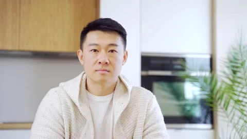 Close-up headshot portrait, face of Asian man looking at camera indoors. Face  Stock Footage 155315032