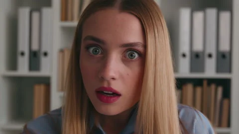Close up headshot shocked afraid amazed wonder astonish female face big eyes Stock Footage 237992498