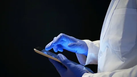 Close up of health professional using a tablet with nitrile gloves. Stock Footage 127578935