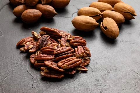 Close up heap of pecan on the black table Stock Photos