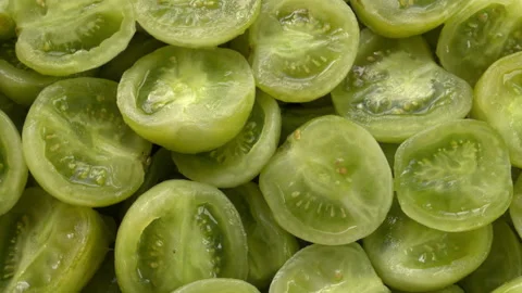 Close-up of a heap of peeled and halved Green Grape Cherry tomatoes. Stock Footage 345086361