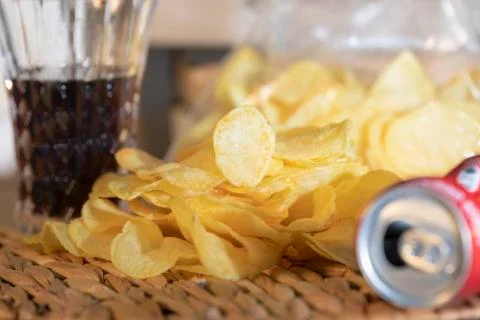 Close-up of heap of potato chips with an empty can Stock Photos