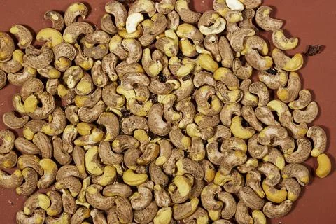 Close-Up Heap of Raw Cashew Nuts With Brown Skin Texture and Natural Yellow Kern Stock Photos