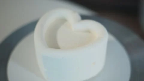 Close-up of heart-shaped confection rotating slowly Stock Footage 336193217