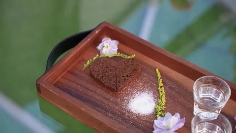 Close-up of Heart-Shaped Rye Bread and Elegant Drink Service on Wooden Tray Stock Footage 345233864
