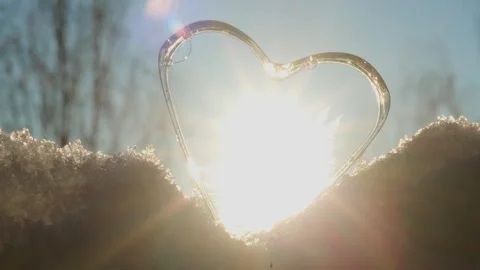 Close-Up of Heart-Shaped Soap Freezing into Ice Crystals on Snow Stock Footage 331166477