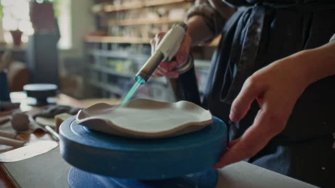 Close-Up of Heating Ceramic Plate with Blowtorch in Pottery Studio Stock Footage 319226920