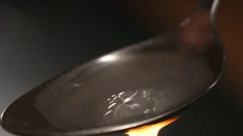 CLOSE UP: Heating a heroin in the spoon Stock Footage 72643557