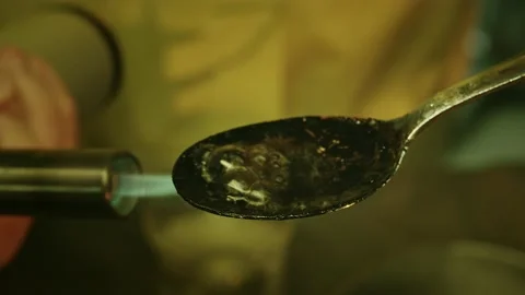 Close-up of heating spoon with liquid drug Stock Footage 150784572