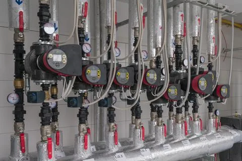 Close-up of a Heating System with Pipes, Pumps and Gauges Stock Photos