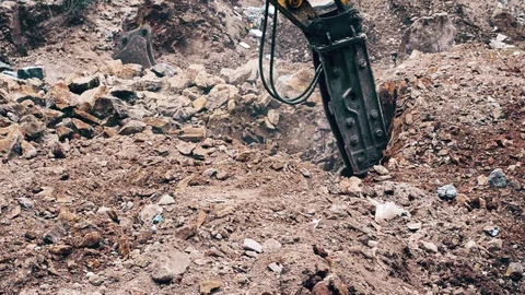 Close up of a heavy duty construction industry excavator machine crushing stones Stock Footage 93554292
