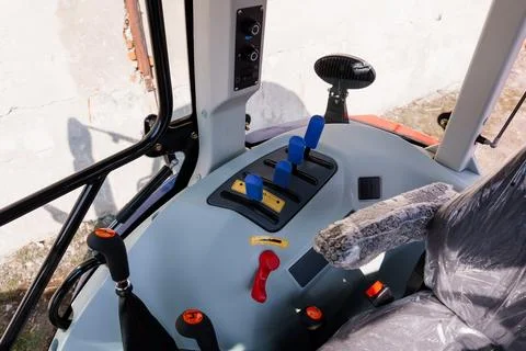 Close up of heavy machinery operator controls in a bright industrial setting  Fotos de archivo