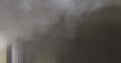 Close-up heavy smoke beginning to fill the upper level of a room in burning Stock Footage 59222541
