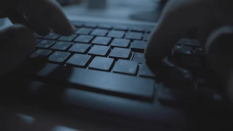 Close up on Hebrew and English computer keyboard as hands type in dark office Stock Footage 331216075