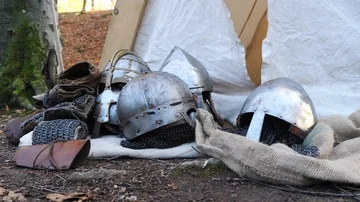 Close-up of the helmets and mail of the Vikings lie near the tent. Stock Footage 86079608