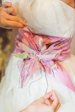 Close up helping the bride to put her wedding dress on Stock Photos