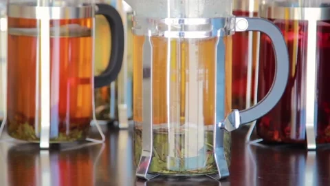 Close-up of herbs floating in a French press, the process of brewing tea Stock Footage 156378032
