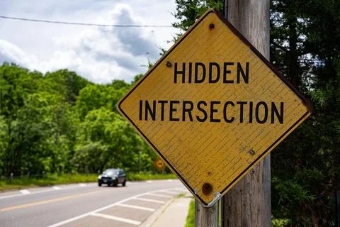 Close up of hidden intersection warning road sign Stock Photos