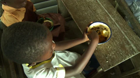 CLOSE UP HIGH ANGLE: ADEISO GIRL STUDENT EATS AND LAUGHS Stock Footage 58069564