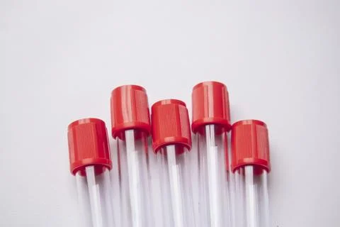 Close-up, high-angle shot of five empty medical blood collection tubes with.. Stock Photos