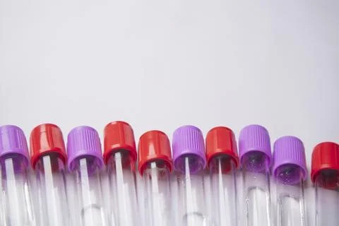Close-up, high-angle shot of ten empty medical blood collection tubes with .. Stock Photos