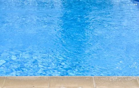 Close-up high angle view of blue  swimming pool at noon . Stock Photos