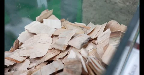 A close-up, high-angle view of a large pile of dry, light brown wood chips Stock Footage 333980460