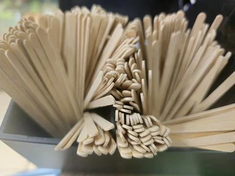 Close-up, high-angle view of numerous light-colored wooden stirring sticks Stock Photos