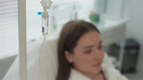 Close-up high-angle view of sick young woman lying in bed at clinic. Ill female Stock Footage 247132218