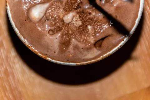 A close-up high angle view of a small bucket of melting chocolate ice cream w Stock Photos
