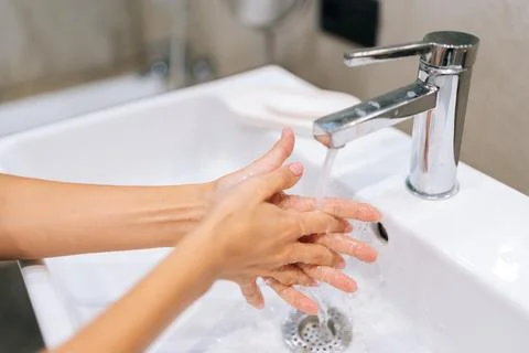 Close-up high-angle view of unrecognizable young woman washing hands with soap Stock Photos