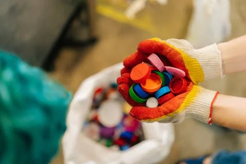 Close-up high-angle view of unrecognizable female volunteer hands in gloves Stock Photos