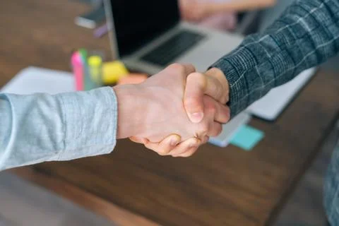 Close-up high-angle view of unrecognizable business men handshaking after close Stock Photos
