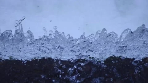 Close up high angle view of water exploding over the edge of a waterfall Stock Footage 143066765