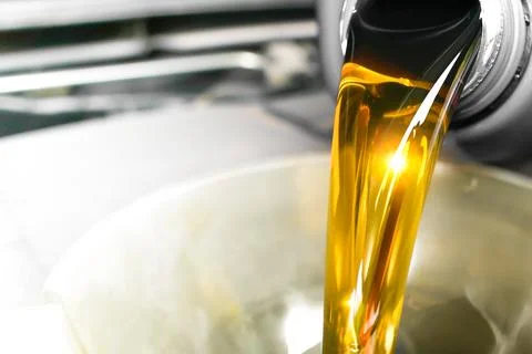 Close up of high quality engine oil being added to a car engine Stock-Fotos