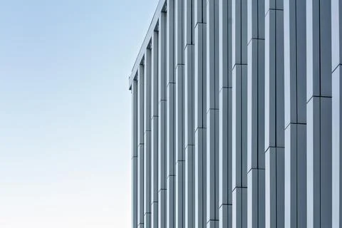 Close-up of a high-rise facade with repeating vertical panels forming a dynam Stock Photos