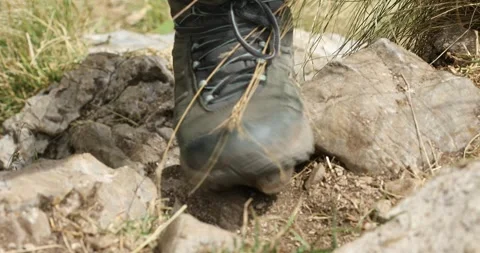 Close-up of a hiker's trekking boot stepping on a rock. Stock Footage 248766307