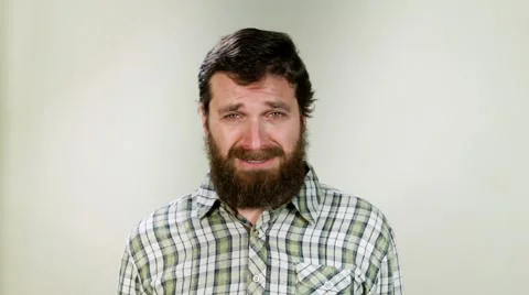 Close up of hipster crying against neutral background Stock Footage 58850682