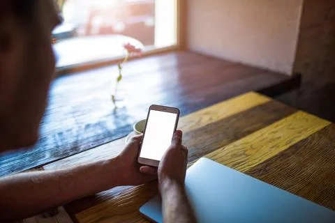 Close up hipster guy using mobile phone with white blank screen background wi Stock Photos