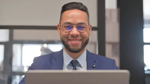 Close up of Hispanic Businessman Smiling at Camera at Workspace Stock Footage 307913145