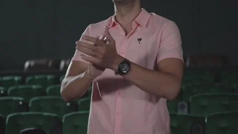 Close up Hispanic latin man stand up applauding while watching movie in theater. Video stock 248602098