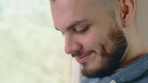 Close-up of hispanic man in bright space processing mobile payment on smartphone Stock Footage 84525590