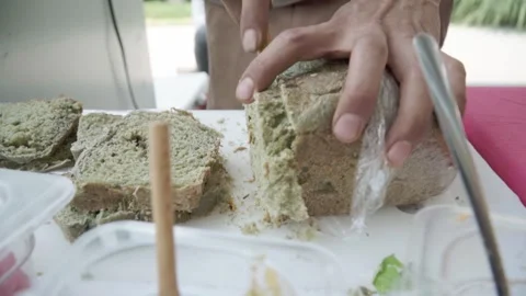 Close-up of Hispanic man working in street restaurant cutting bread. Stock Footage 281924519