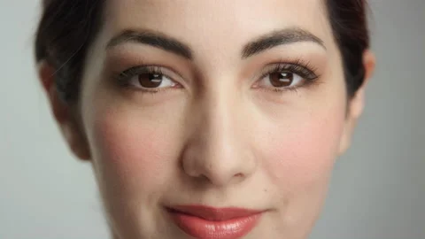 Close on hispanic model's beautiful face as she opens eyes with subtle smile Stock Footage 193924726