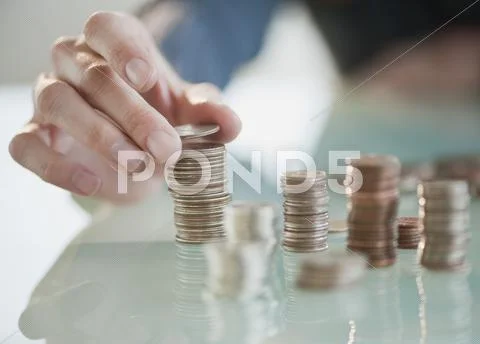 Close up of hispanic woman stacking coins Stock Photos