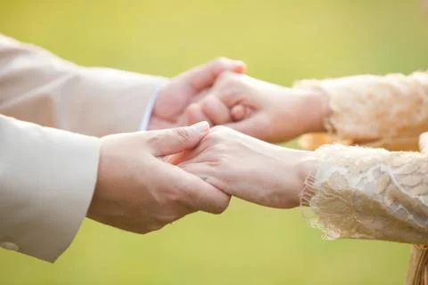 Close-up Holding Hands of lovers on wedding day in Thailand Stock Photos