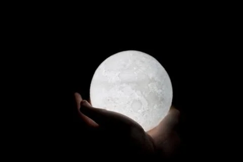 Close up holding moon in palm Stock Photos